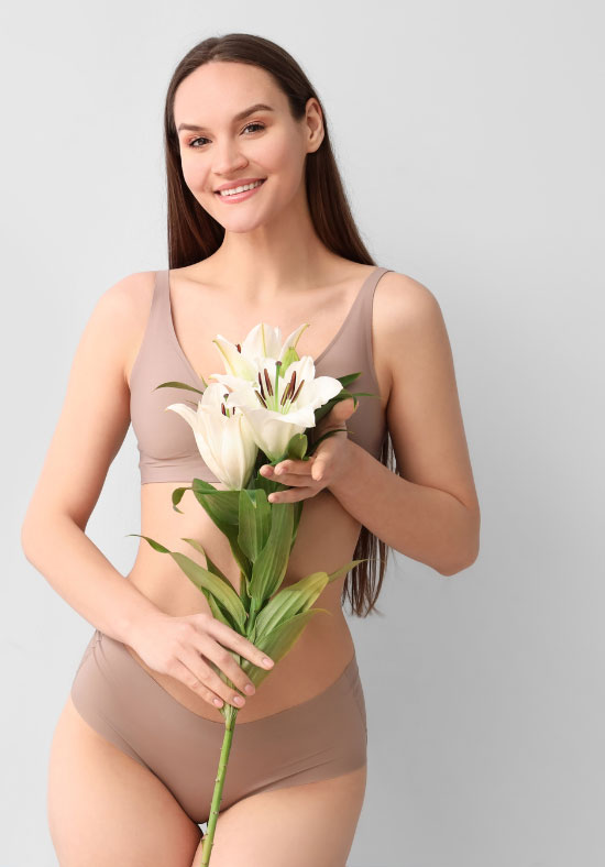Confident Female in Underwear Posing With Flowers